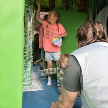 two children point to the changing colour of the bubble tube