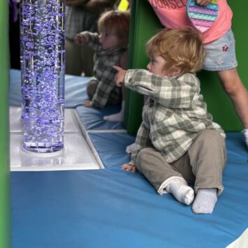 small boy points to bubbles