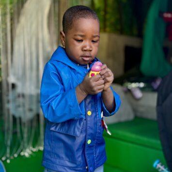 A Young boy watched a small fidget toy