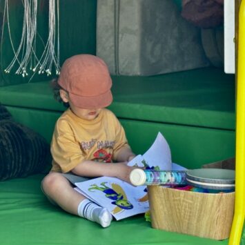 small boy obscured by large orange hat reads Goody's Big Feelings